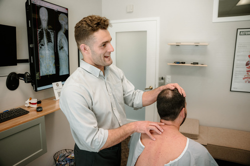 Dr. Nic Mueller working on a patient coming in with reports of shoulder pain in Ann Arbor